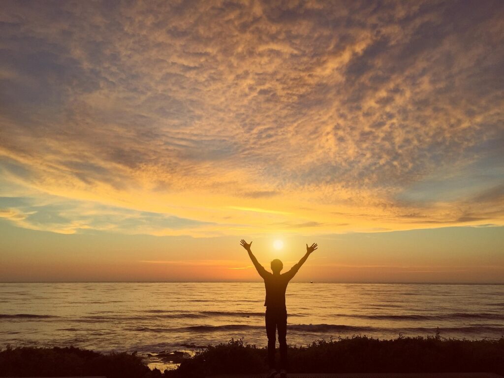 man on beach during sunrise finding healing, hope and freedom from sex and porn addiction