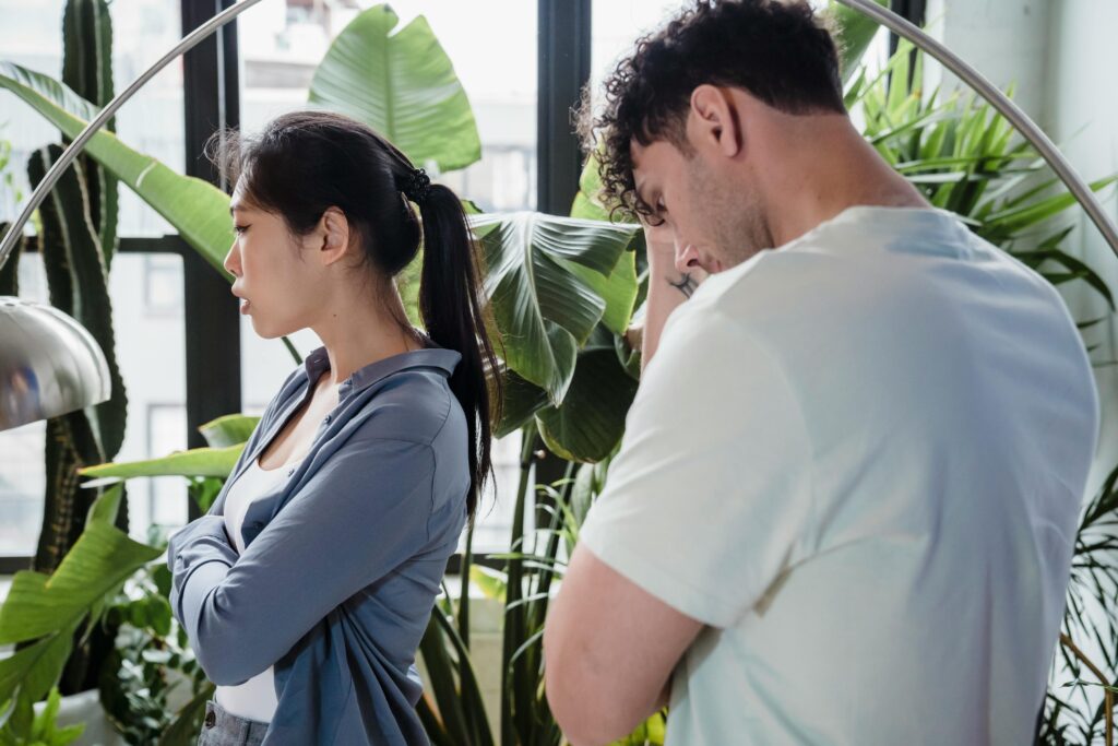 Couple arguing in an indoor garden, representing relationship conflict, emotional tension, and struggles linked to porn addiction and trust issues