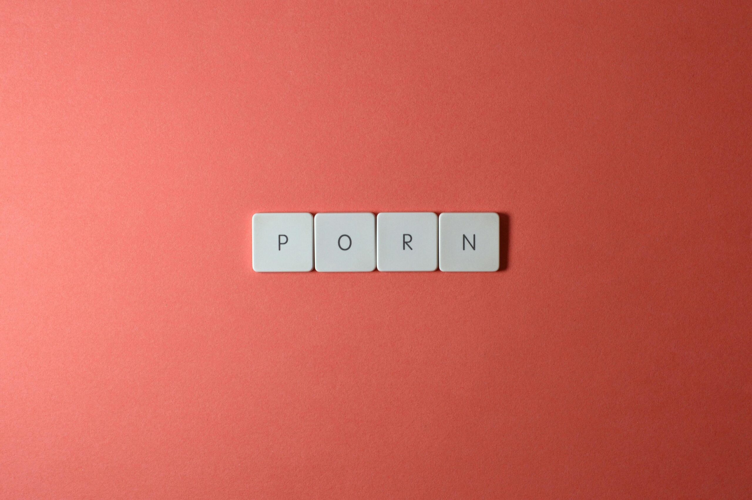 The word "PORN" displayed on a digital screen symbolising online pornography addiction and compulsive viewing habits