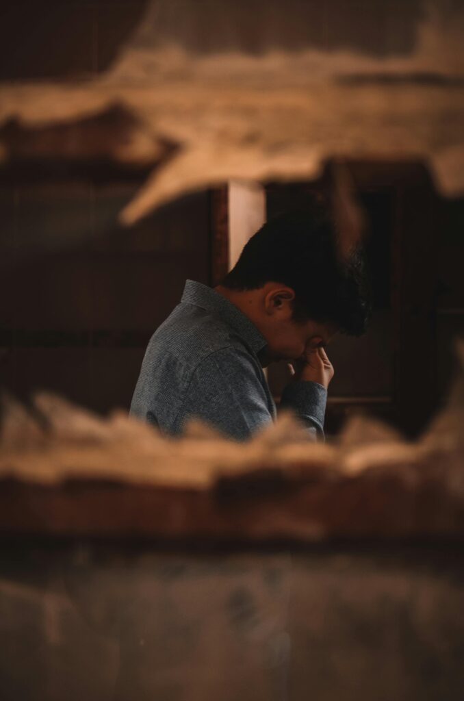 pexels-photo-3292556-3292556 A man in deep thought captured indoors through a broken wall.
