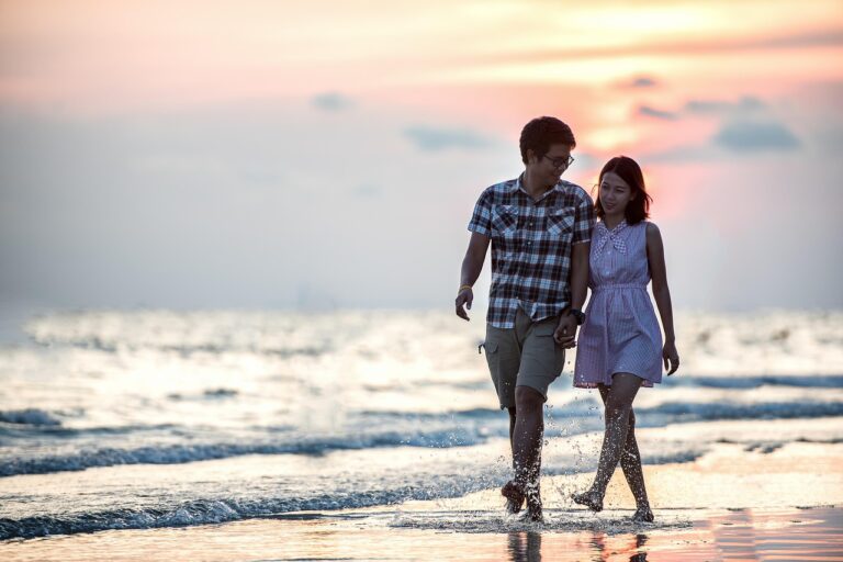 Couple walking on the beach at sunset symbolising healing and reconnection in a relationship