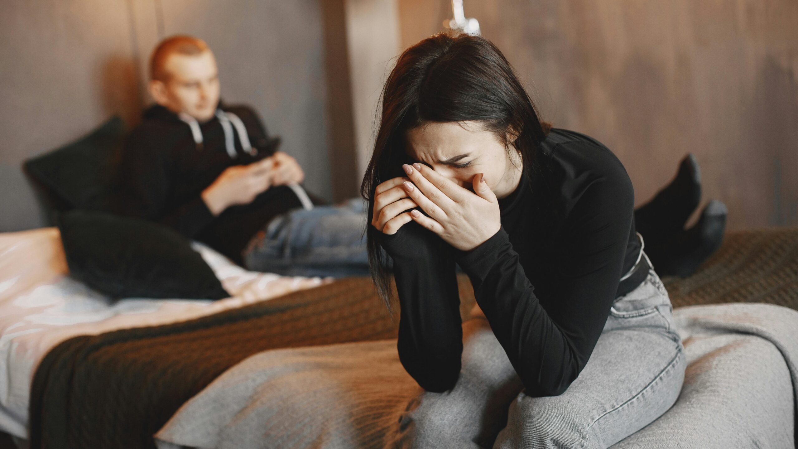 A couple experiencing tension and sadness due to betrayal trauma.
